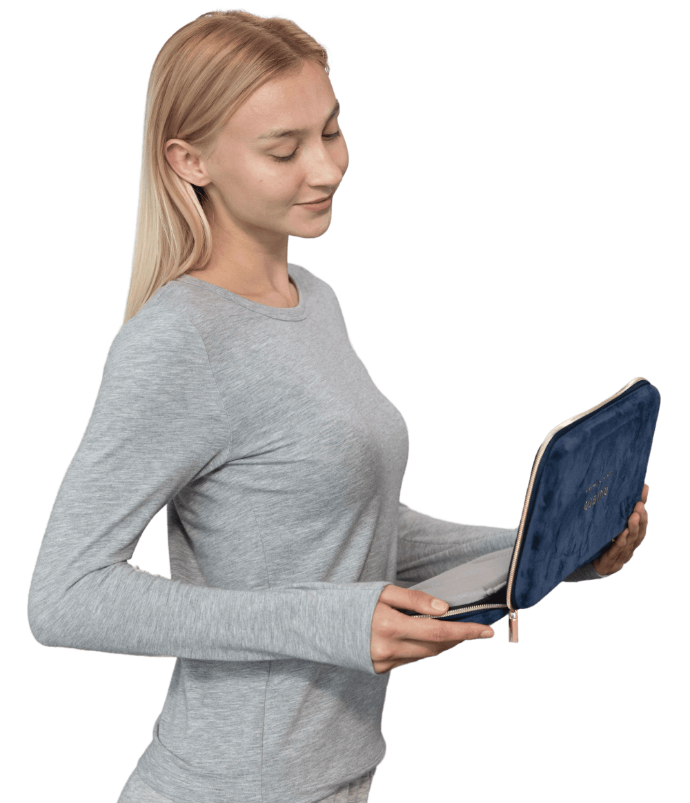 Woman holding a Quieto device, preparing for a restful, snore-free night of sleep.